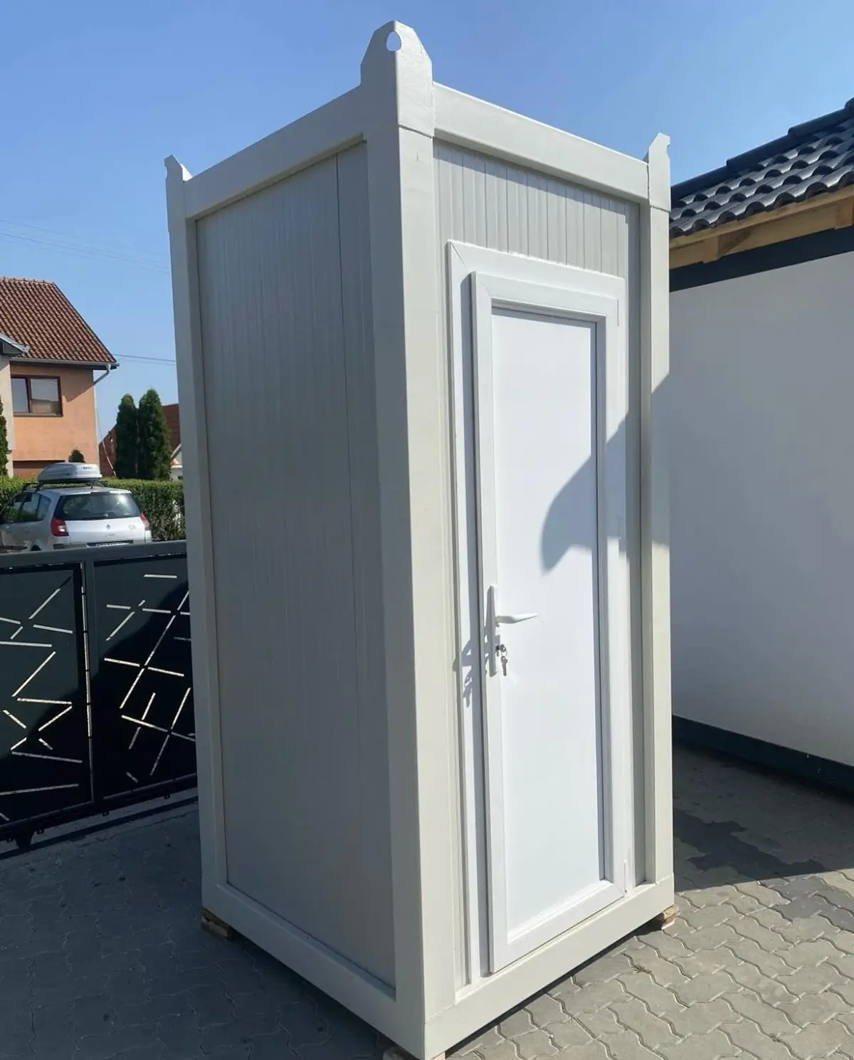 White deluxe flushing porta potty with closed door on a paved path in Hellertown PA