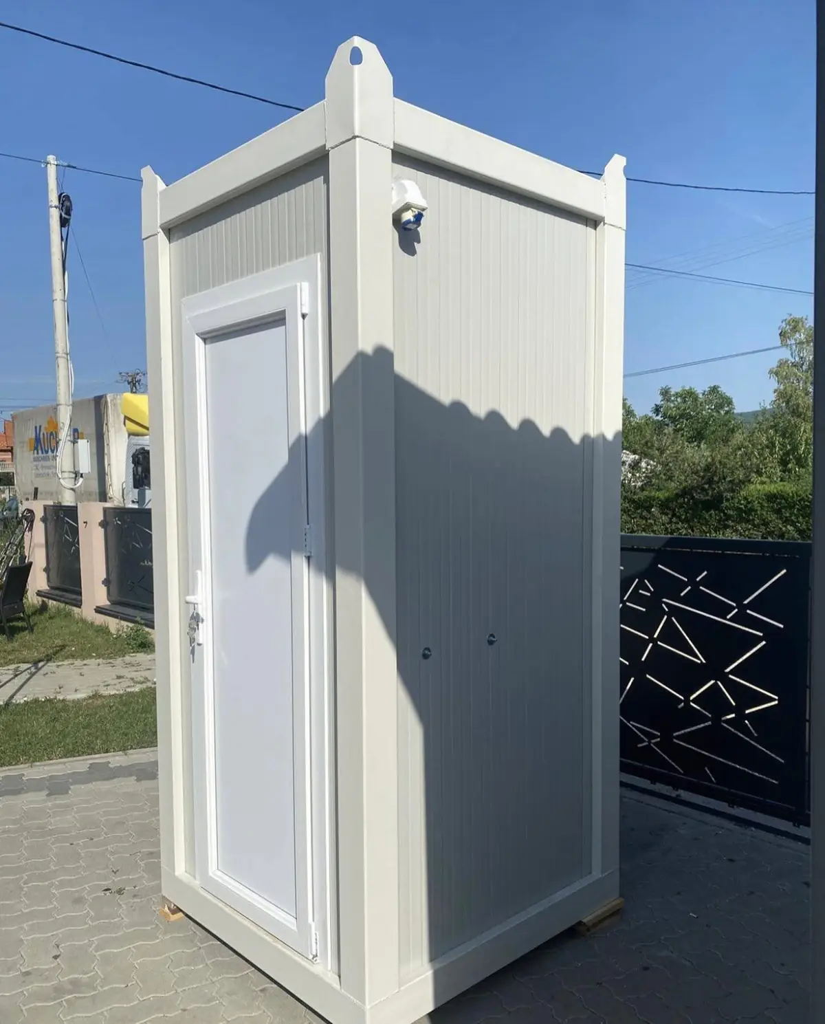 Side view of a white deluxe flushing porta potty with roof vent in Easton PA