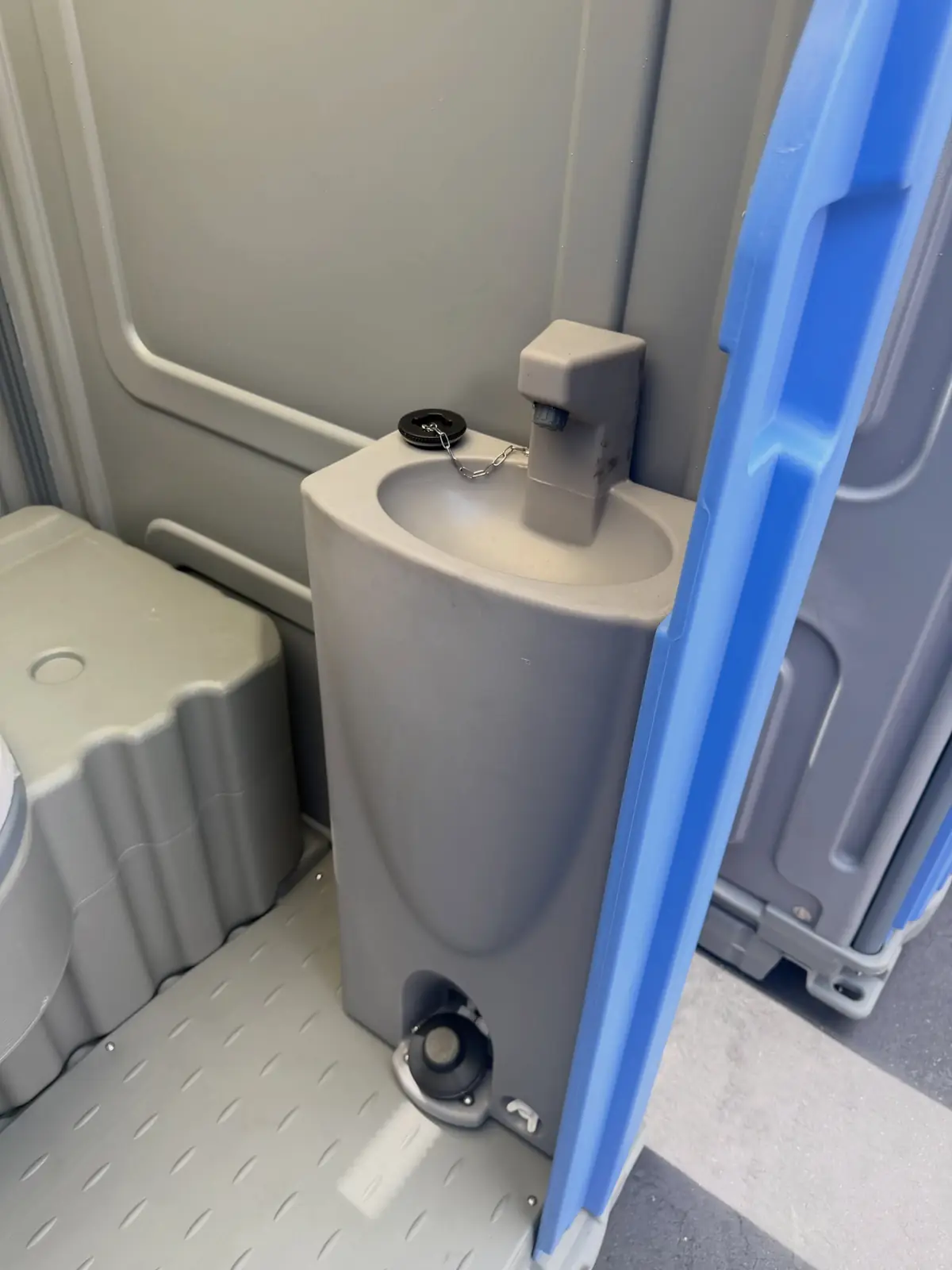 Foot-pump sink inside a PolyJohn Fresh Flush porta potty