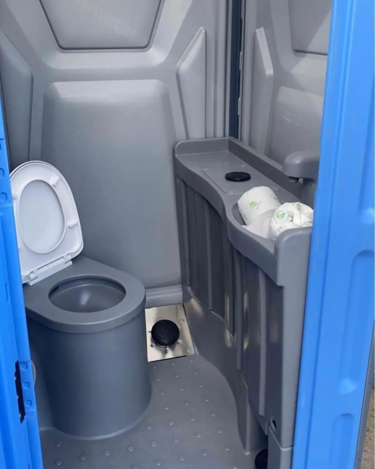Interior of a PolyJohn PJN3 showing the toilet seat, urinal and tissue holders