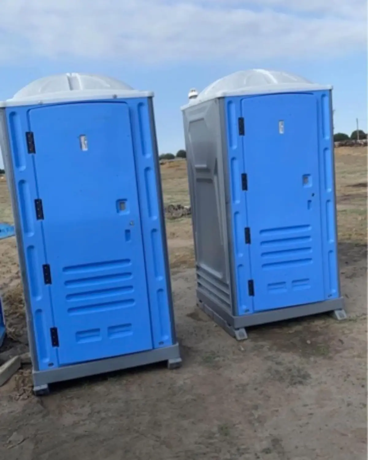 Two blue PJN3 porta potties on a graded dirt pad at a Bethlehem Township home build