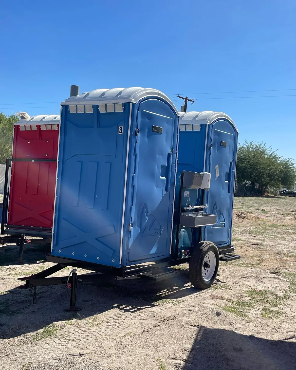 Blue PJN3 units strapped on a delivery trailer at a dirt jobsite
