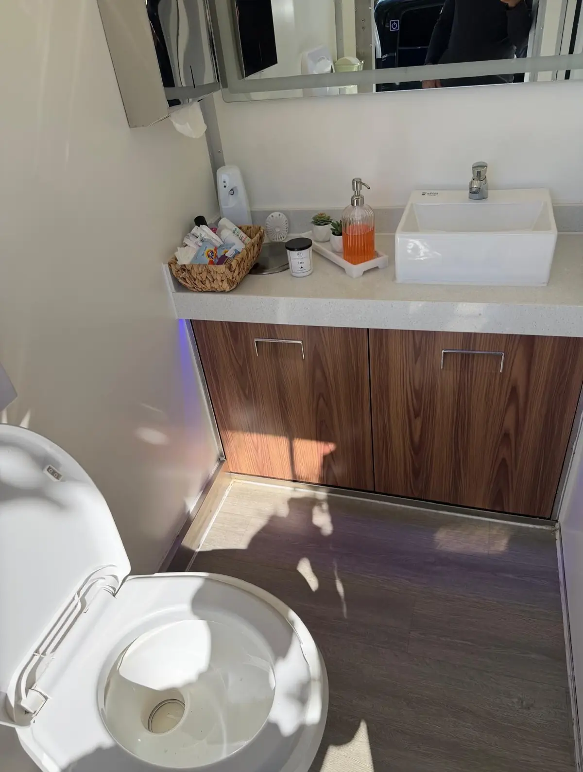Restroom trailer vanity with vessel sink, soap and amenities tray